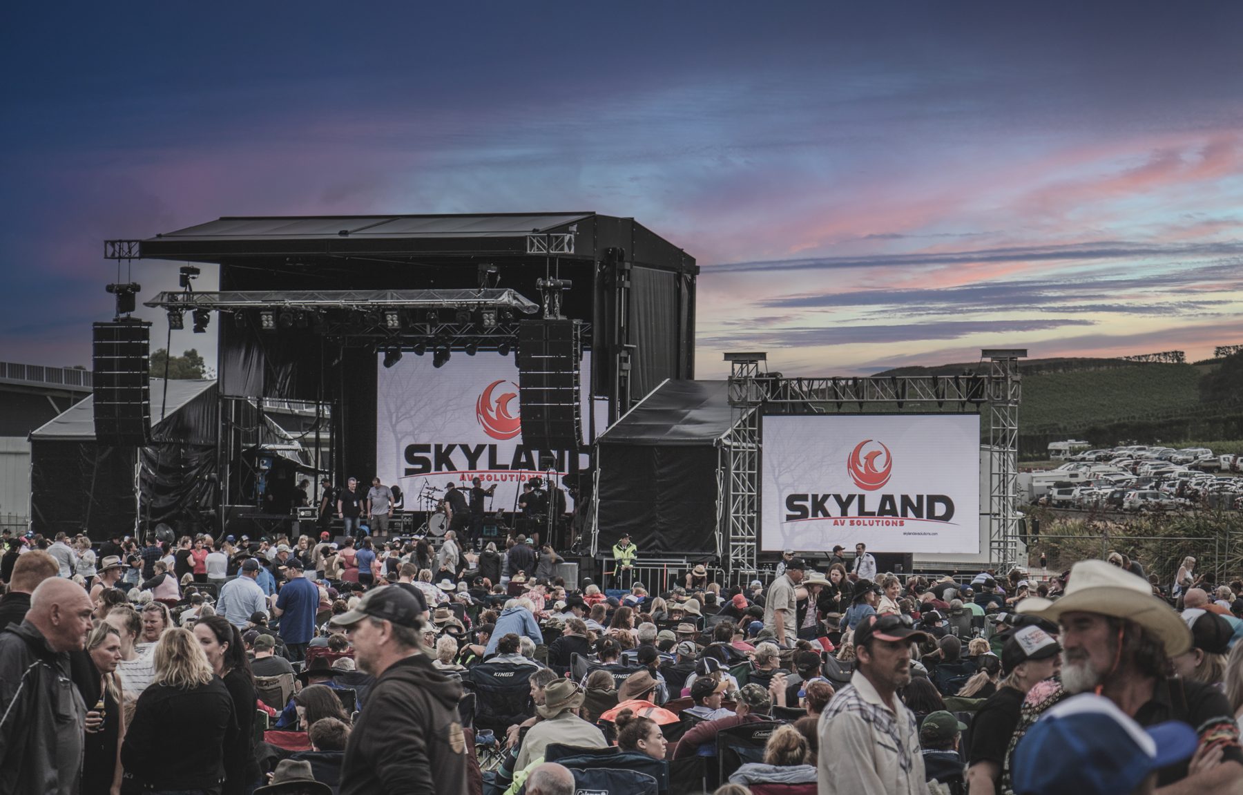 Skyland AV Solutions branded stage and screens at a large outdoor festival in Tasmania